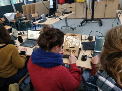 femme qui tient une planchette de bois découpée au laser