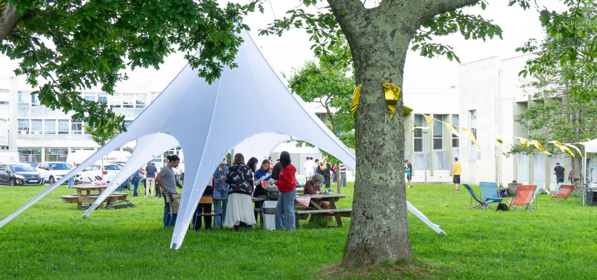 Photographie d'un groupe d'étudiant sous une tonnelle par une journée ensoleillée.