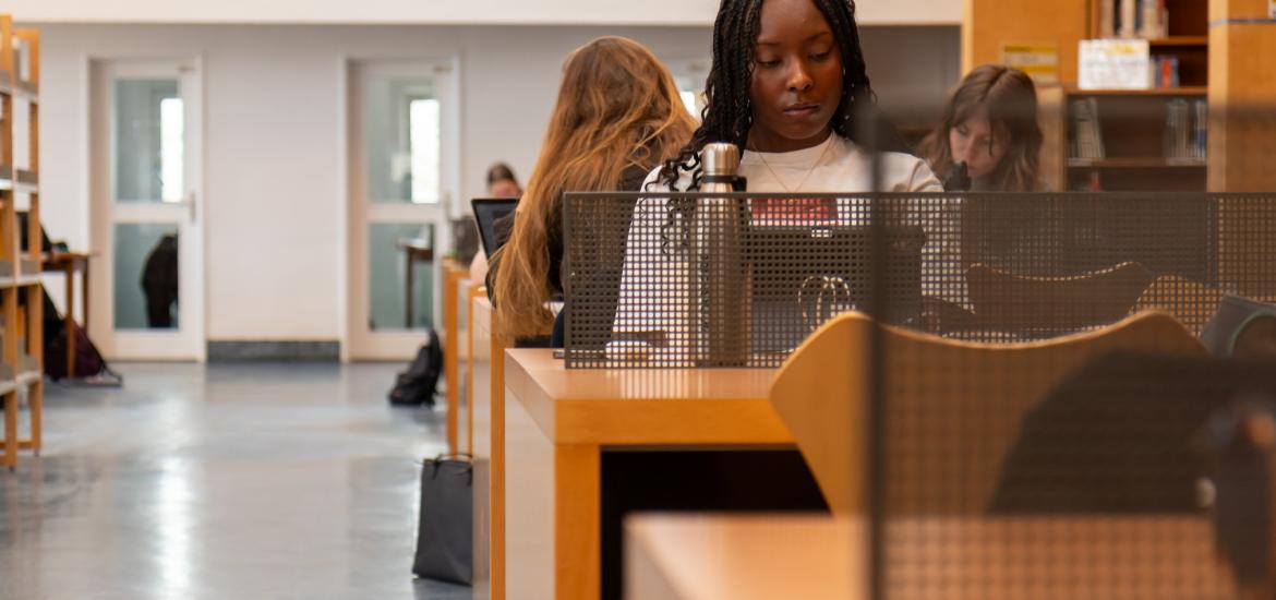 Photographie d'une étudiante qui travaille à la bibliothèque
